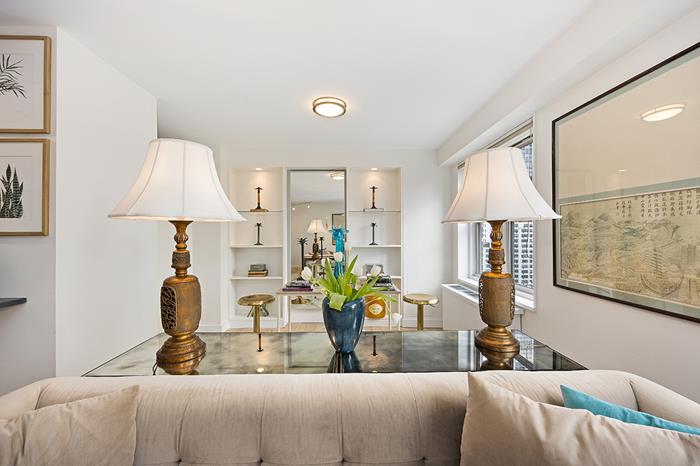 137 East 36th Street, Unit 11B Manhattan, NY 10016 - Photo 2 of 22 a living room with furniture and a lamp