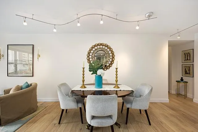 a dining room with furniture and wooden floor