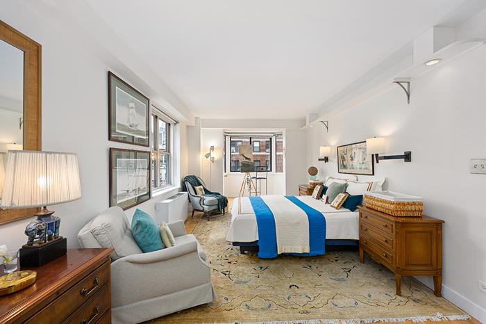 137 East 36th Street, Unit 11B Manhattan, NY 10016 - Photo 9 of 22 a spacious bedroom with two beds and a lamp