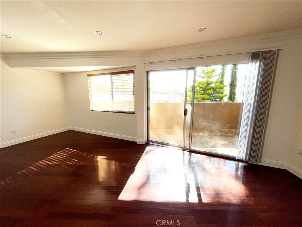 100 Cliff Drive, Unit 8 Laguna Beach, CA 92651 - Photo 2 of 46 a view of an empty room with wooden floor and a window