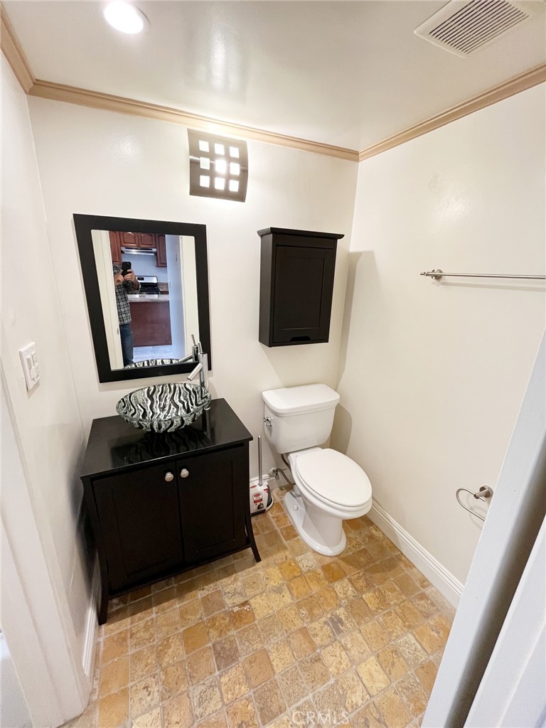 100 Cliff Drive, Unit 8 Laguna Beach, CA 92651 - Photo 23 of 46 a living room with a couch and a flat screen tv