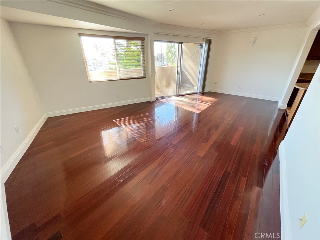 100 Cliff Drive, Unit 8 Laguna Beach, CA 92651 - Photo 3 of 46 a view of an empty room with wooden floor and a window
