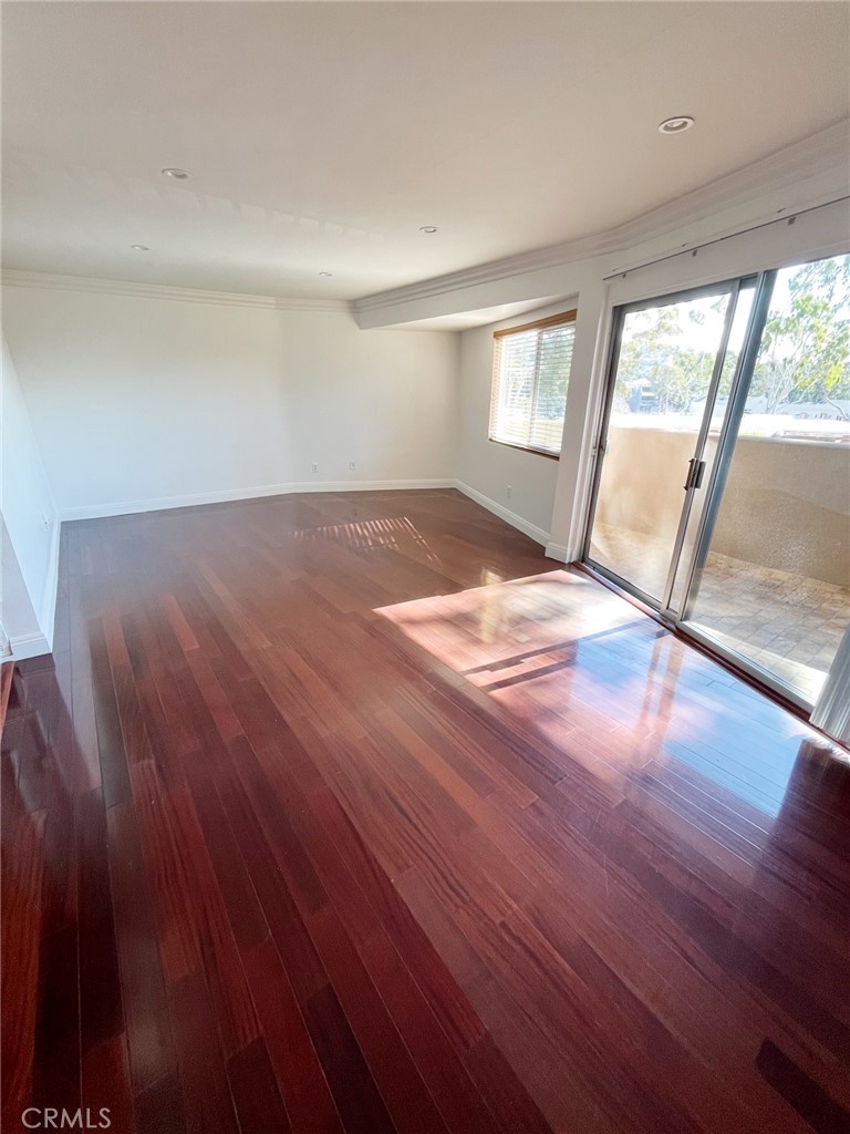 100 Cliff Drive, Unit 8 Laguna Beach, CA 92651 - Photo 7 of 46 a view of an empty room with wooden floor and a window