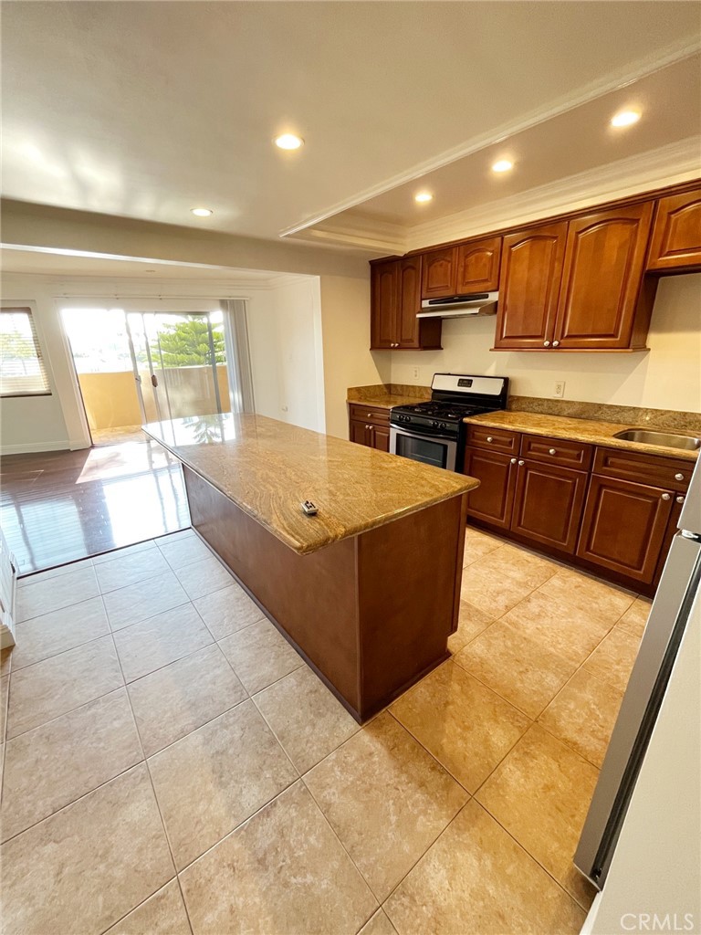 100 Cliff Drive, Unit 8 Laguna Beach, CA 92651 - Photo 9 of 46 a large kitchen with stainless steel appliances granite countertop a large counter top and a stove top oven