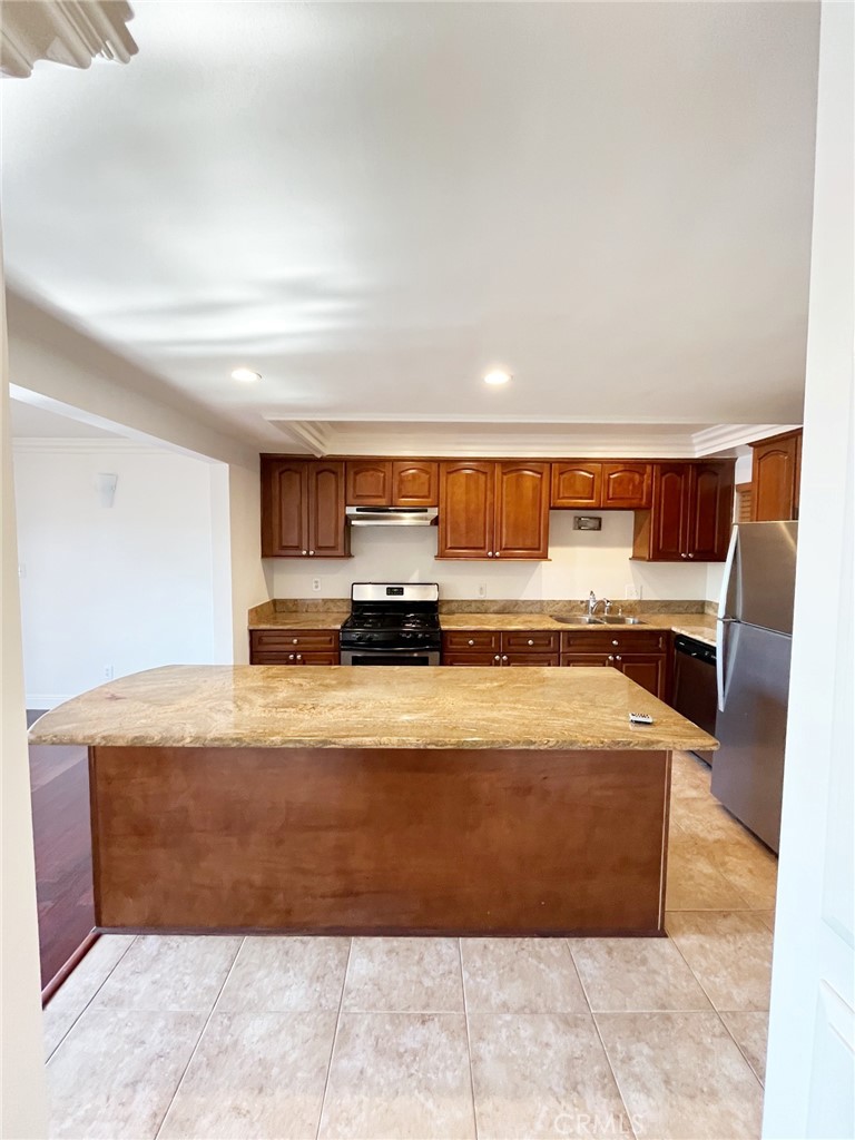100 Cliff Drive, Unit 8 Laguna Beach, CA 92651 - Photo 10 of 46 a large kitchen with stainless steel appliances granite countertop a large counter top and a fireplace