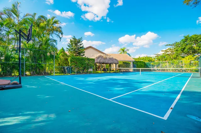 a view of a chairs and table in patio with a small yard