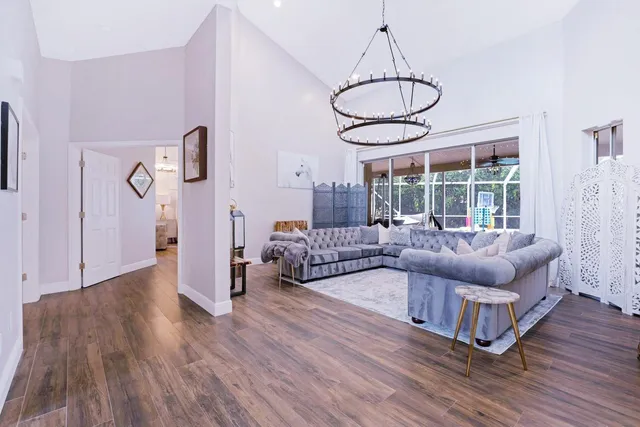 a view of a street with potted plants and a large tree