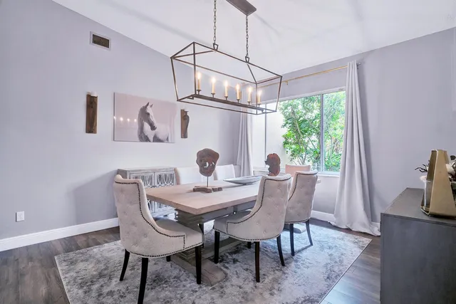 a spacious bedroom with a bed and a chandelier