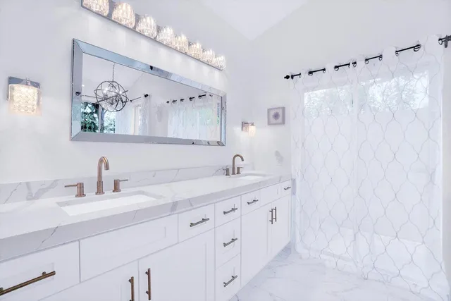 a living room with stainless steel appliances kitchen island granite countertop a table chairs and a view of living room