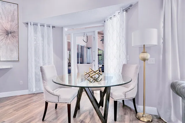 a kitchen with stainless steel appliances granite countertop a refrigerator and a stove with wooden floor