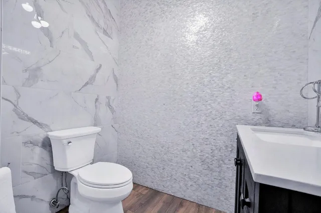 a bathroom with a sink a toilet and mirror