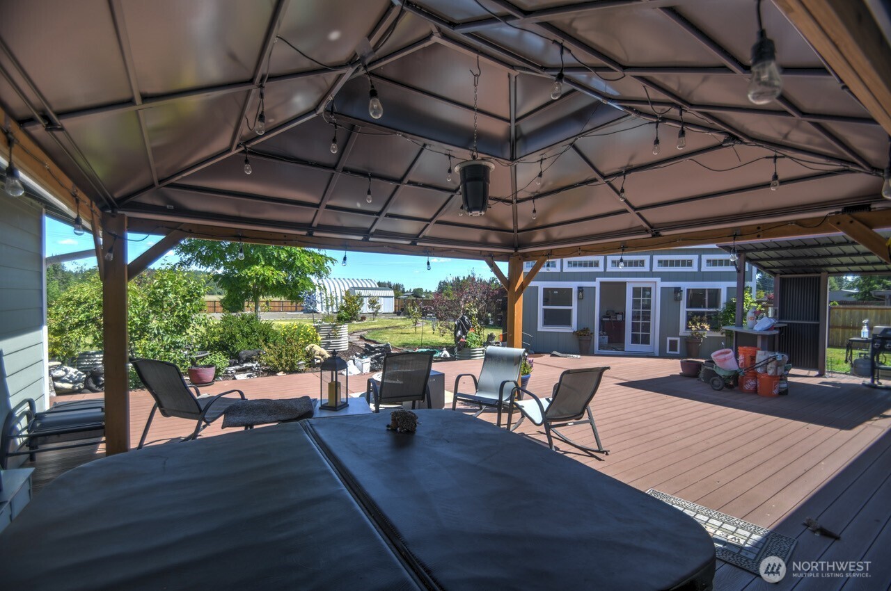5922 184th Lane Southwest Rochester, WA 98579 - Photo 15 of 34 a view of a patio with chairs and wooden floor