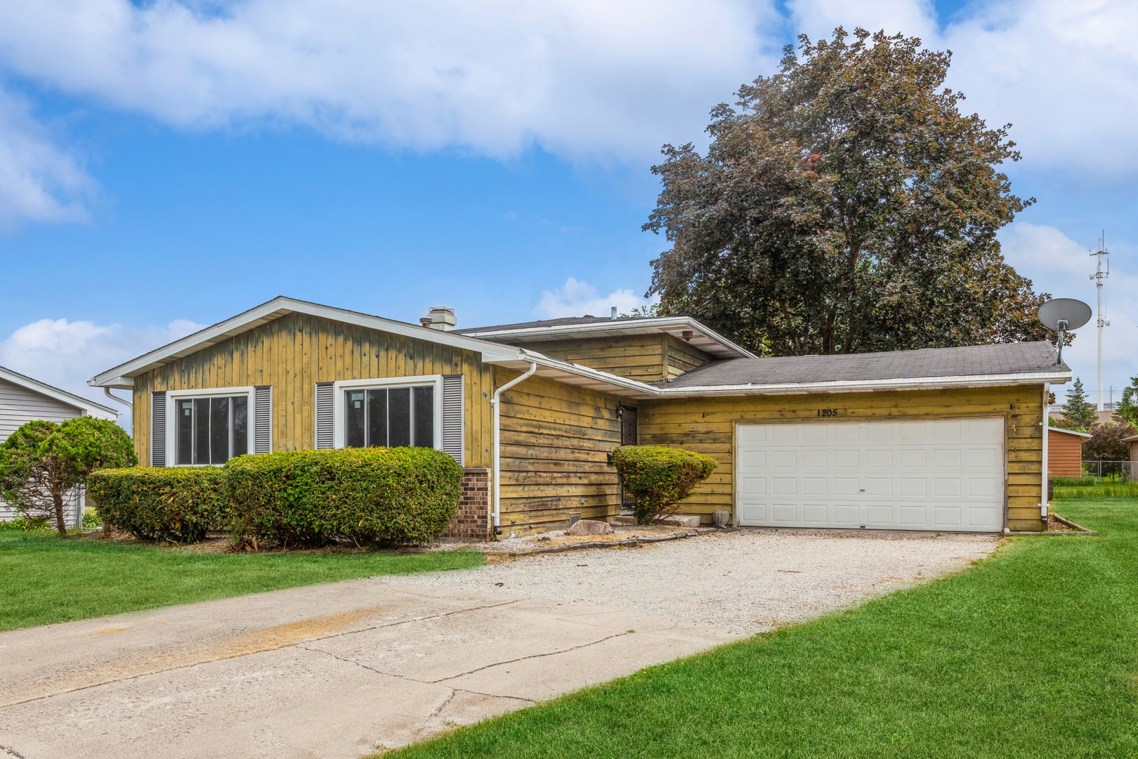 1205 Comet Drive Aurora, IL 60505 - Photo 2 of 15 a front view of a house with a garden and yard
