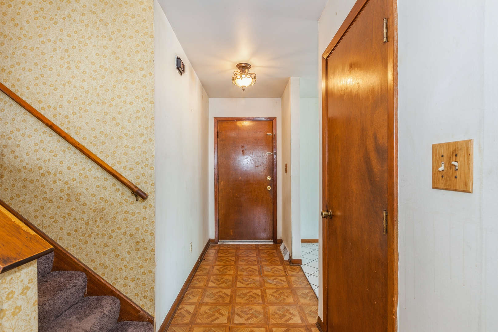1205 Comet Drive Aurora, IL 60505 - Photo 8 of 15 a view of a hallway with wooden floor and staircase