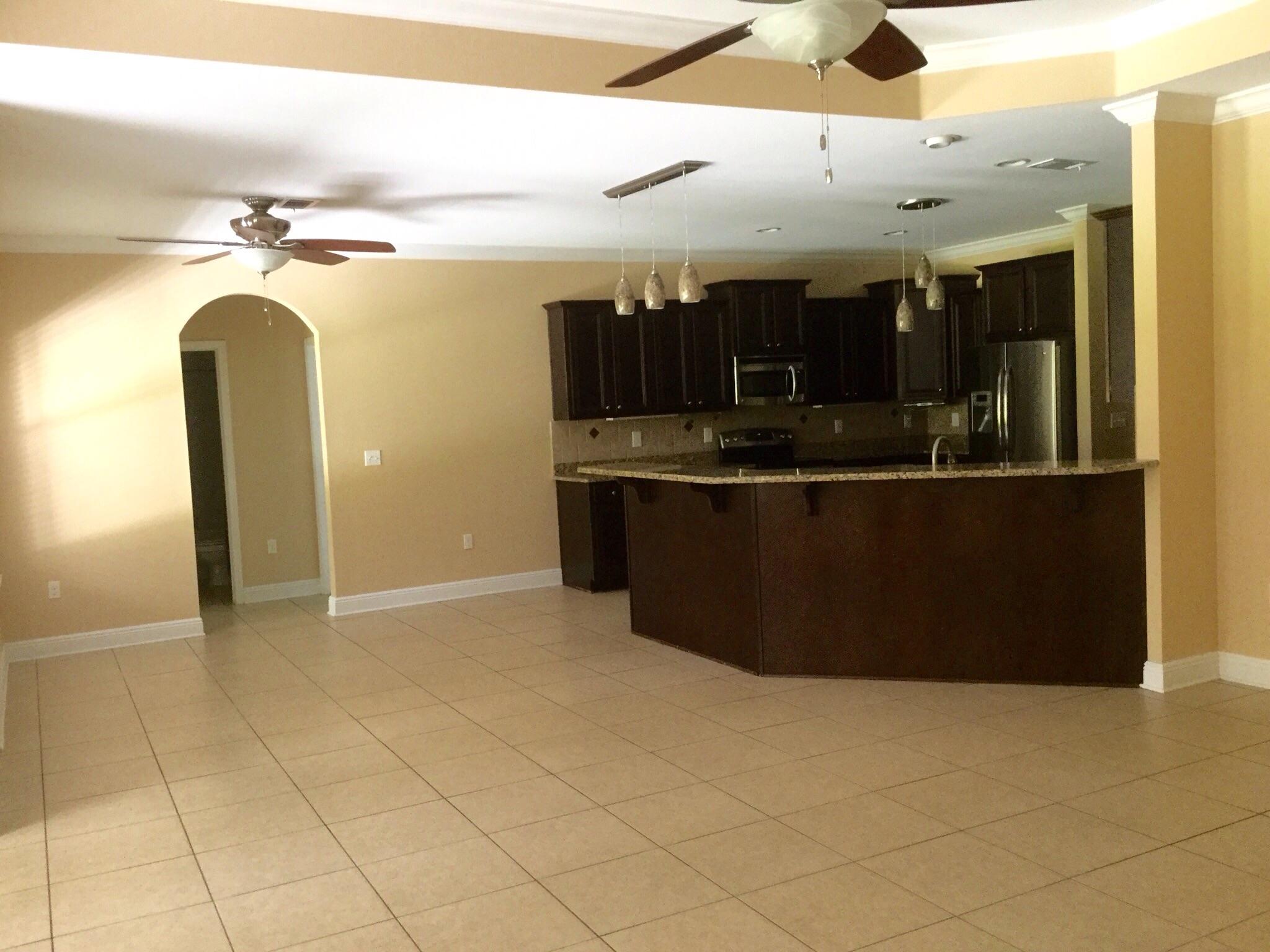 630 Red Fern Road Crestview, FL 32536 - Photo 20 of 38 a kitchen with stainless steel appliances granite countertop a sink and a refrigerator