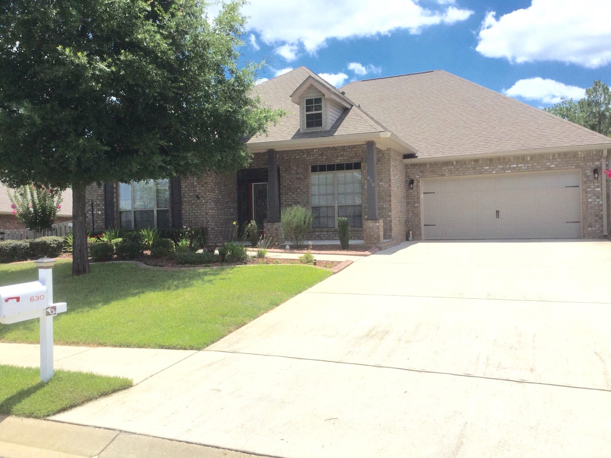 630 Red Fern Road Crestview, FL 32536 - Photo 5 of 38 a front view of a house with a yard
