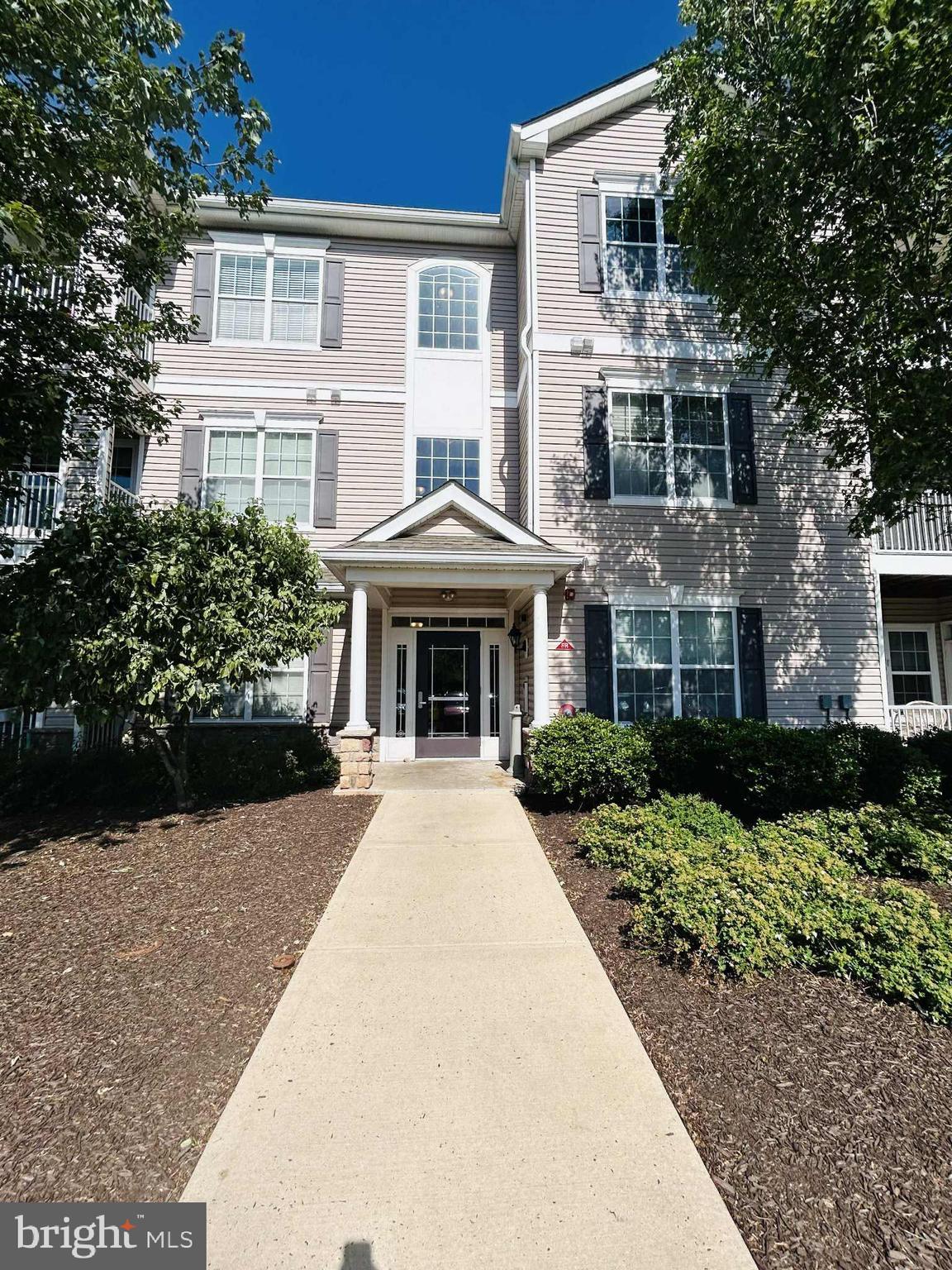 1028 Timberlake Drive Ewing, NJ 08618 - Photo 1 of 11 a front view of a house with a yard and potted plants