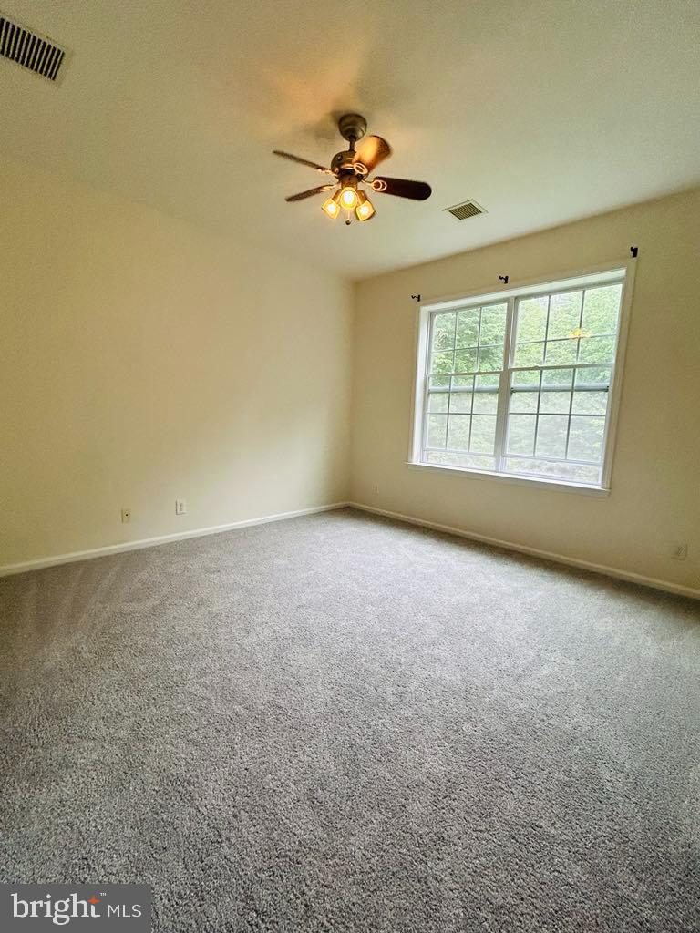 1028 Timberlake Drive Ewing, NJ 08618 - Photo 7 of 11 an empty room with a ceiling fan and window