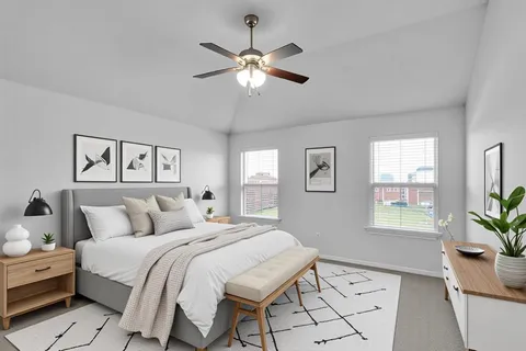 a bedroom with a large bed and a window