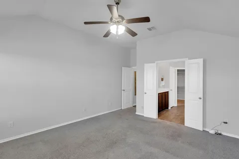 a view of a livingroom with a ceiling fan and entryway