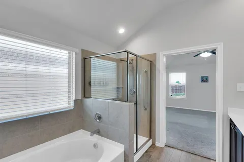 a bathroom with a tub shower and sink