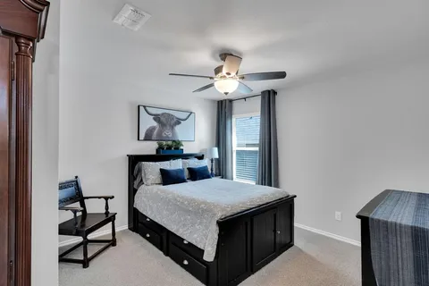 a bedroom with a bed and a chandelier