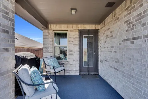 a balcony with table and chairs