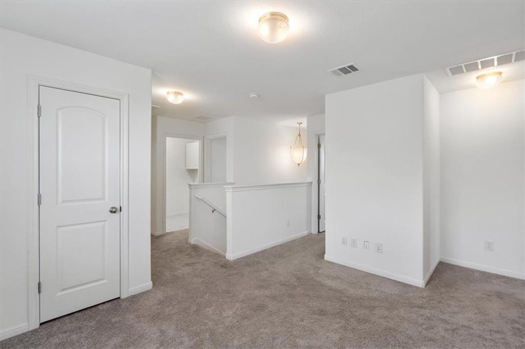 6500 Routenburn Street Austin, TX 78754 - Photo 19 of 38 Unfurnished room featuring light colored carpet and baseboards