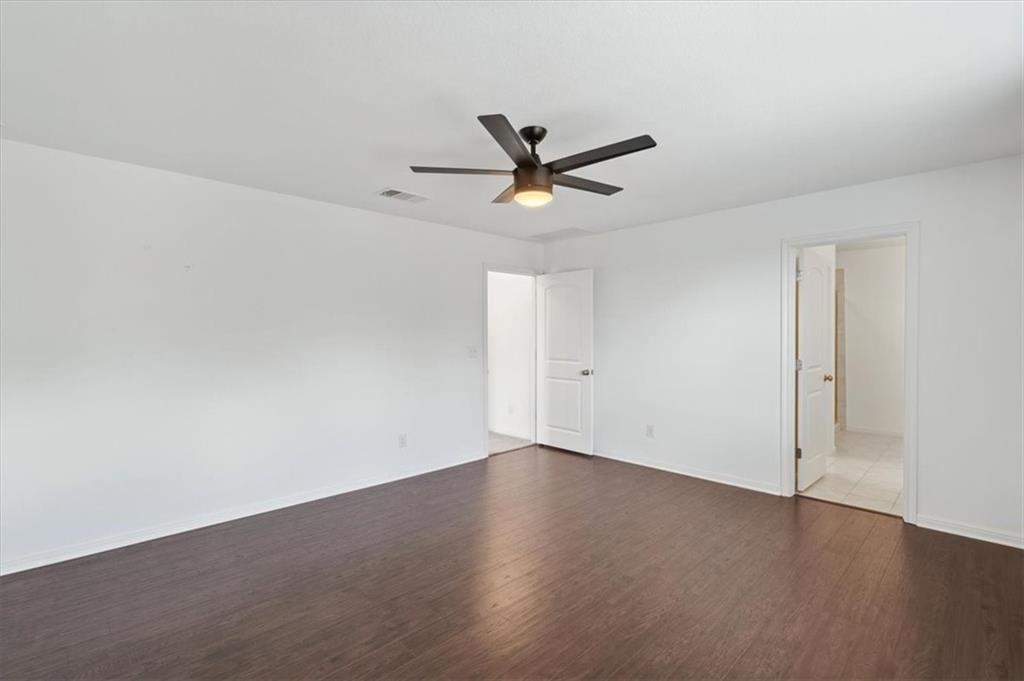 6500 Routenburn Street Austin, TX 78754 - Photo 20 of 38 Unfurnished bedroom with dark wood-style floors and ceiling fan