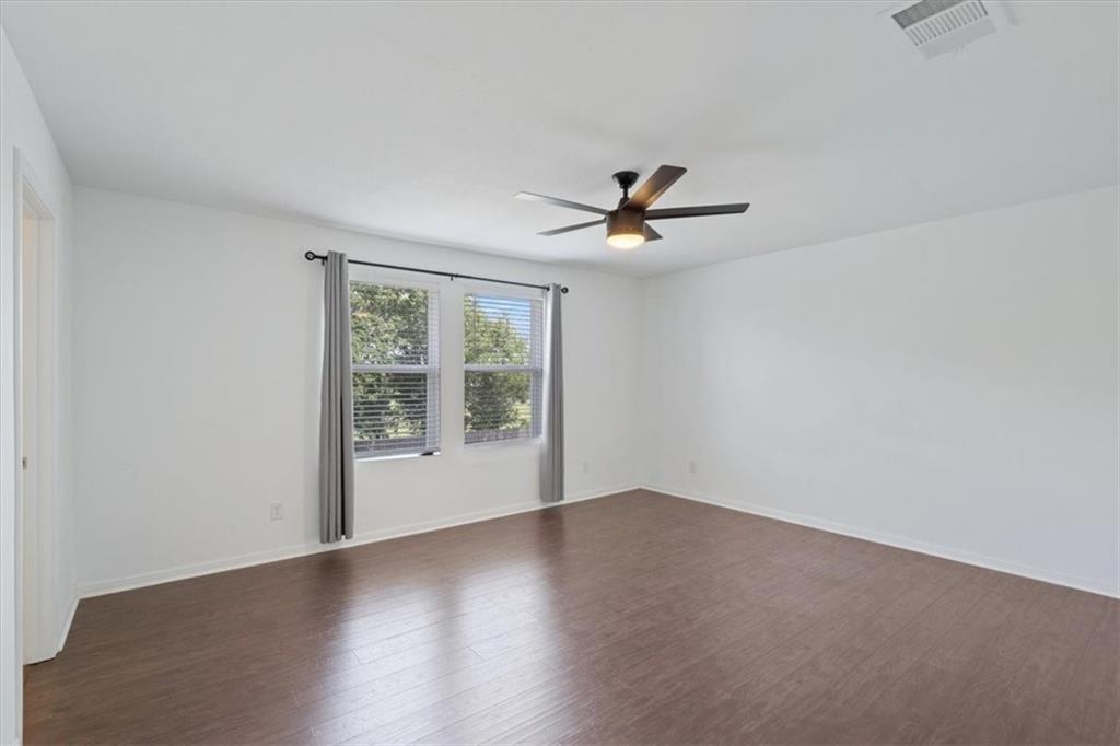 6500 Routenburn Street Austin, TX 78754 - Photo 21 of 38 Empty room featuring dark wood-style floors and a ceiling fan