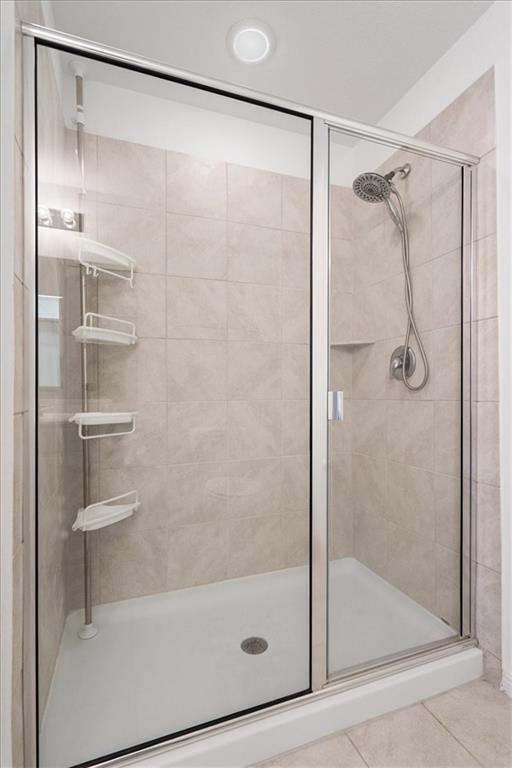 6500 Routenburn Street Austin, TX 78754 - Photo 23 of 38 Bathroom featuring a stall shower and tile patterned floors