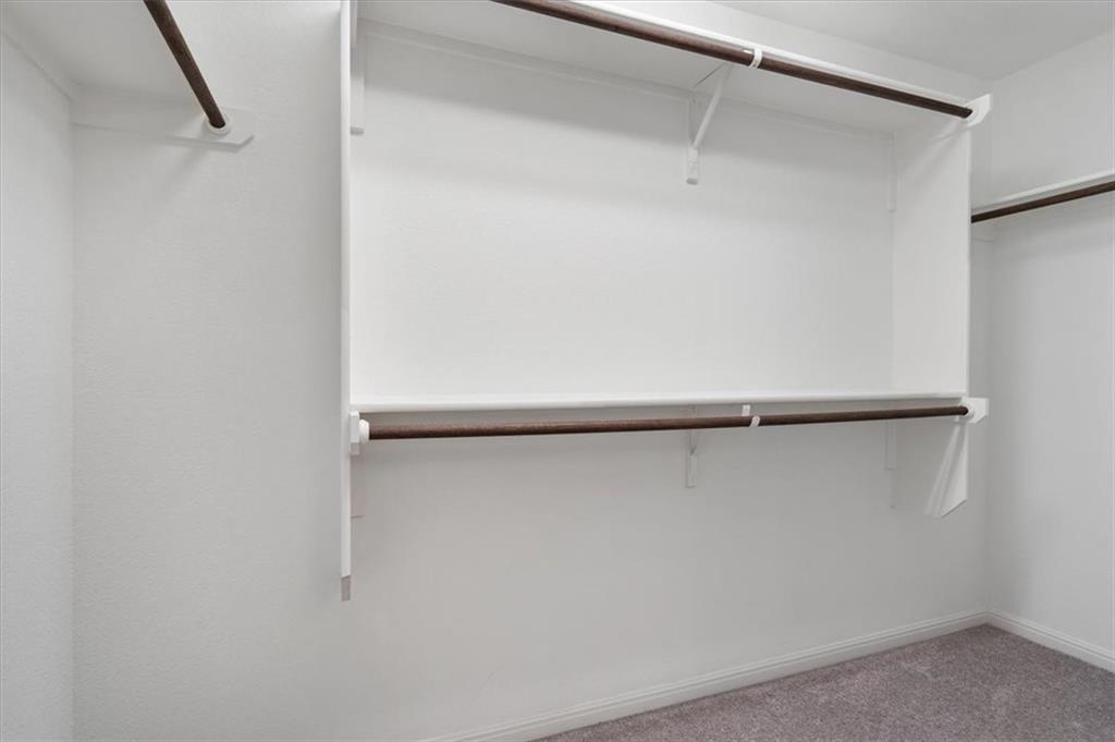 6500 Routenburn Street Austin, TX 78754 - Photo 24 of 38 Walk in closet with carpet floors