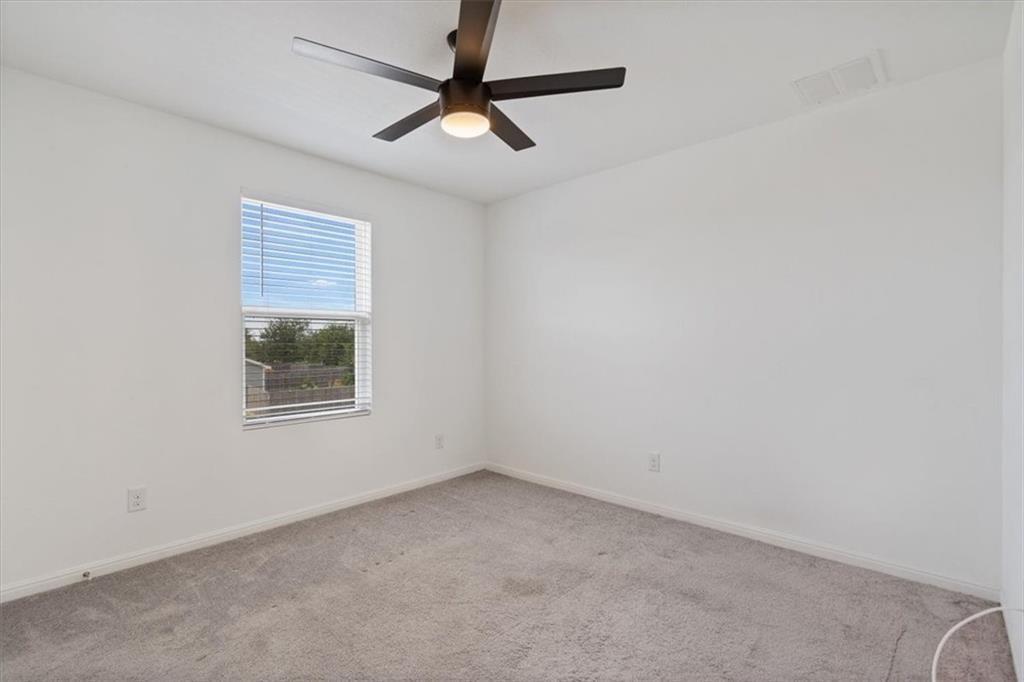 6500 Routenburn Street Austin, TX 78754 - Photo 27 of 38 Spare room with light carpet and ceiling fan