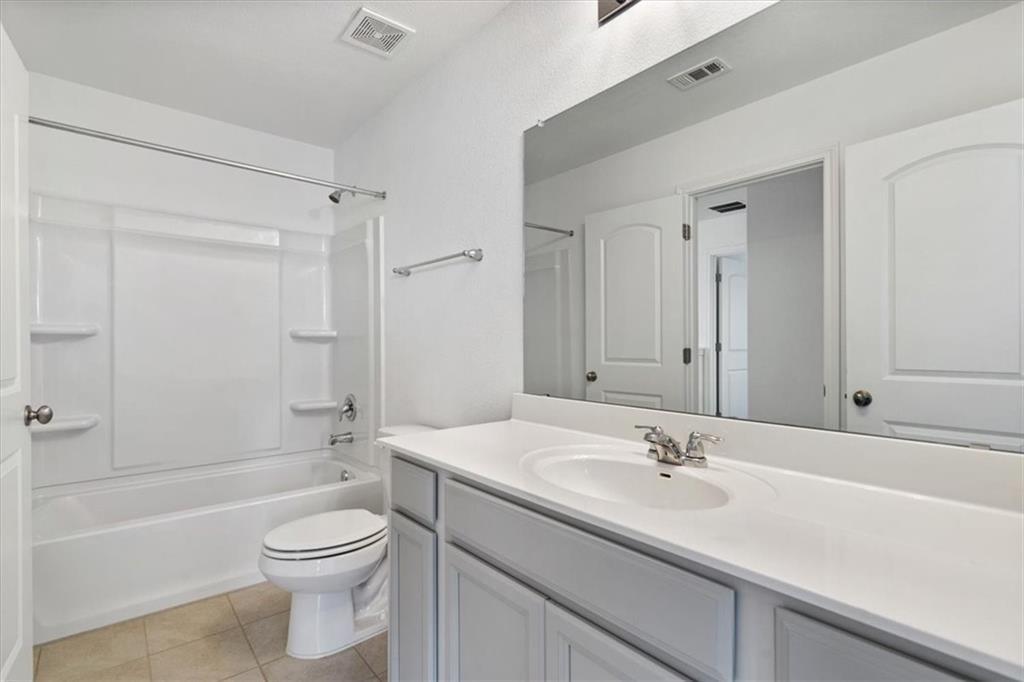 6500 Routenburn Street Austin, TX 78754 - Photo 28 of 38 Full bath with vanity, bathtub / shower combination, and light tile patterned floors