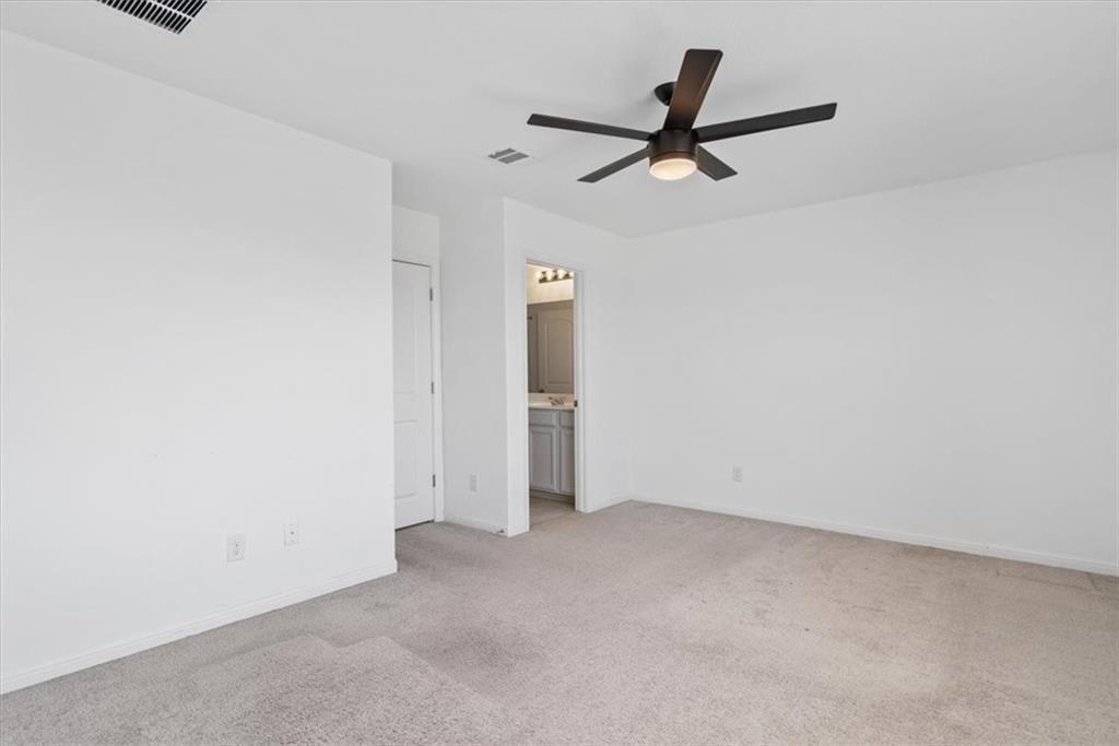 6500 Routenburn Street Austin, TX 78754 - Photo 31 of 38 Unfurnished bedroom with light carpet, ceiling fan, and ensuite bathroom