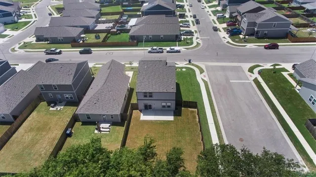 an aerial view of residential houses with outdoor space