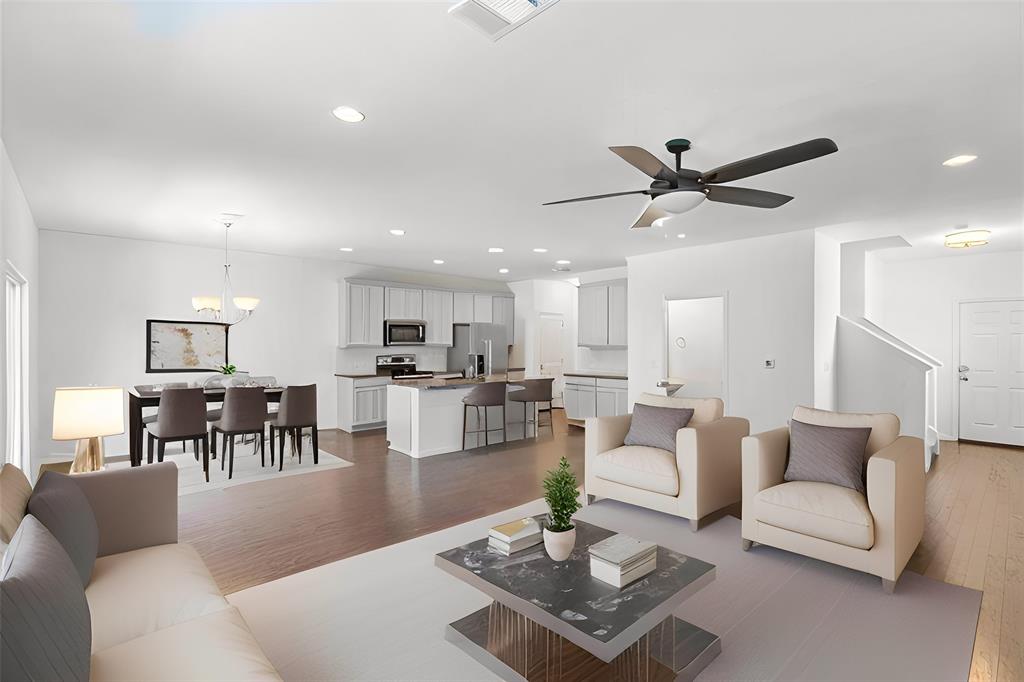 6500 Routenburn Street Austin, TX 78754 - Photo 6 of 38 Living area with dark wood finished floors, a ceiling fan, and a chandelier