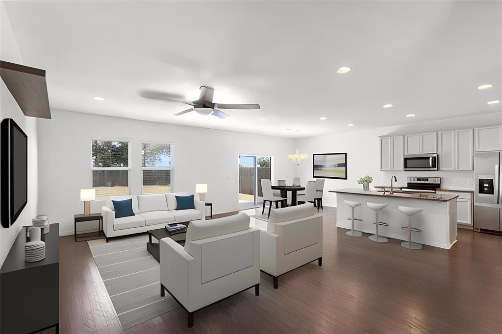 6500 Routenburn Street Austin, TX 78754 - Photo 7 of 38 Living area with dark wood-style floors, a ceiling fan, and hanging lights