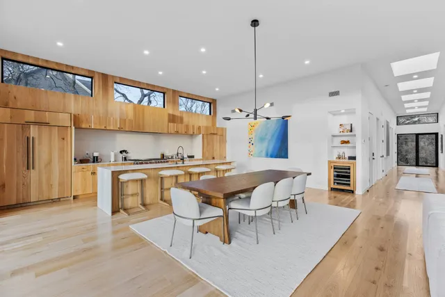 a dining hall with stainless steel appliances granite countertop a stove kitchen island a refrigerator and a fireplace