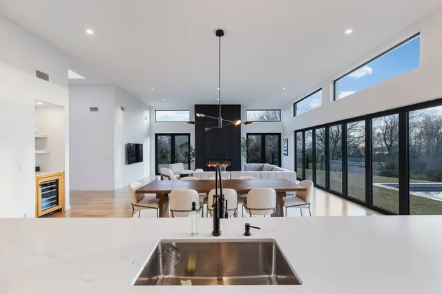 a living room with furniture large window and flat screen tv