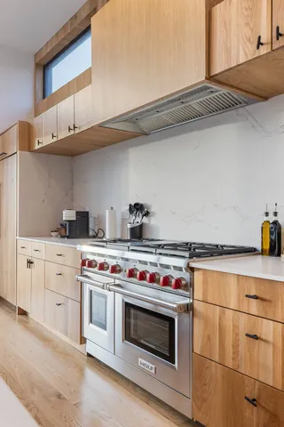 a white stove top oven sitting inside of a kitchen