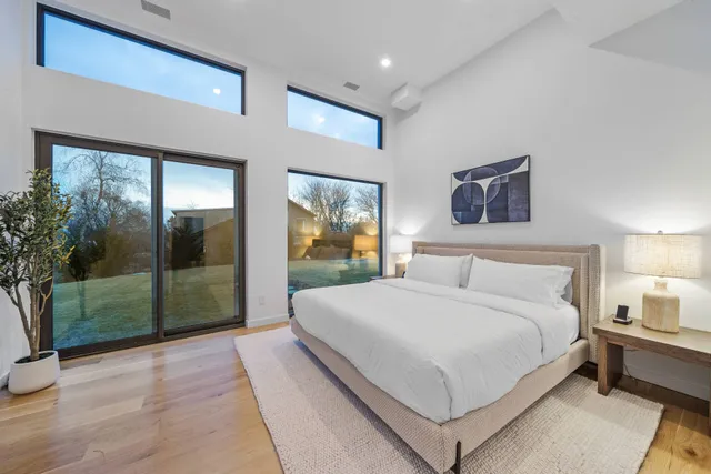 a spacious bedroom with a large bed and a window