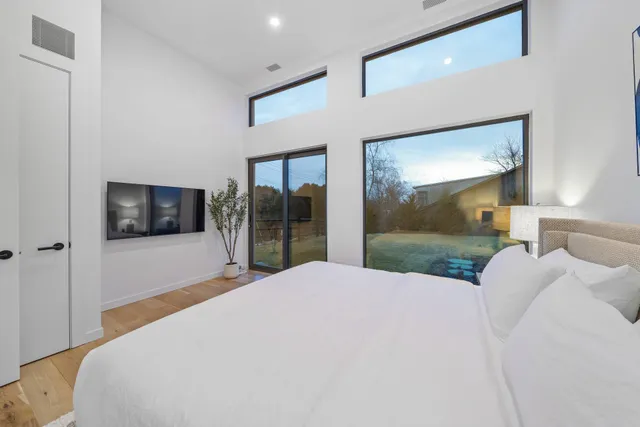 a bedroom with a bed and a flat screen tv