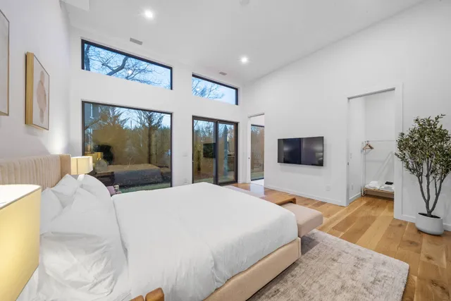 a bedroom with a large bed and a flat screen tv