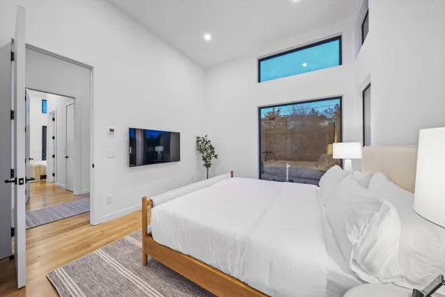 a bedroom with a bed and a flat screen tv