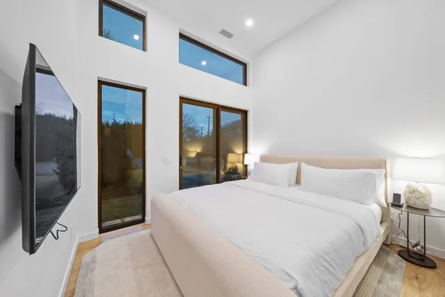 a bedroom with a bed and a mirror