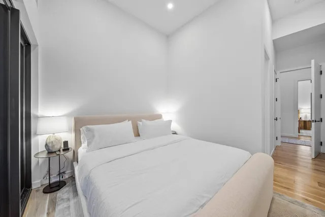 a bedroom with a bed and a lamp