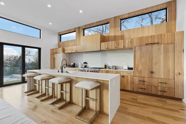 a kitchen with stainless steel appliances granite countertop a stove a sink and a refrigerator