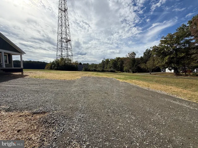 a kitchen with granite countertop a refrigerator stove and sink