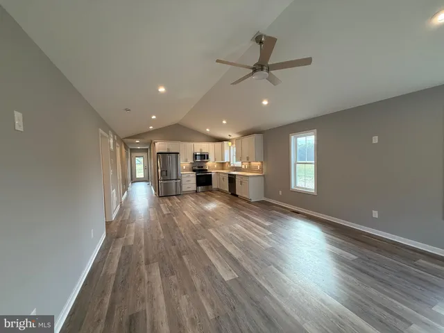 a view of walk in closet with wooden floor